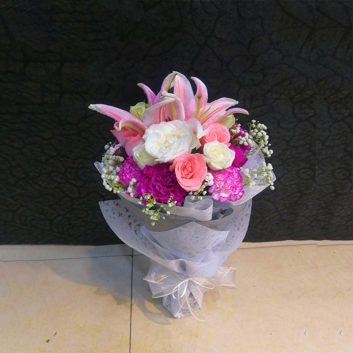 Pink Lily Roses & Carnations Arranged in a Ribbon Bouquet
